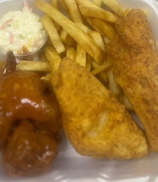 Fried fish fillets and a sauced wing with fries and coleslaw
